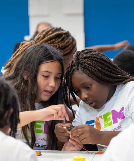 Two girls participating in a STEM event